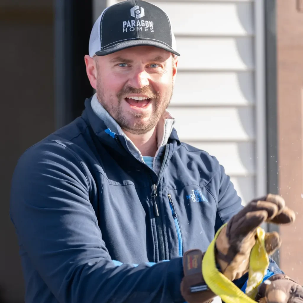 Mark Singleton, owner of Paragon Homes, smiling and wearing a cap with the Paragon Homes logo, showcasing a collaborative spirit in custom home building.